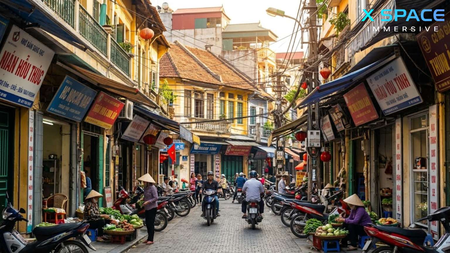 A dynamic daytime photograph of a narrow, lively street in the Hanoi Old Quarter, filled with motorbikes, vendors, and ancient colonial buildings