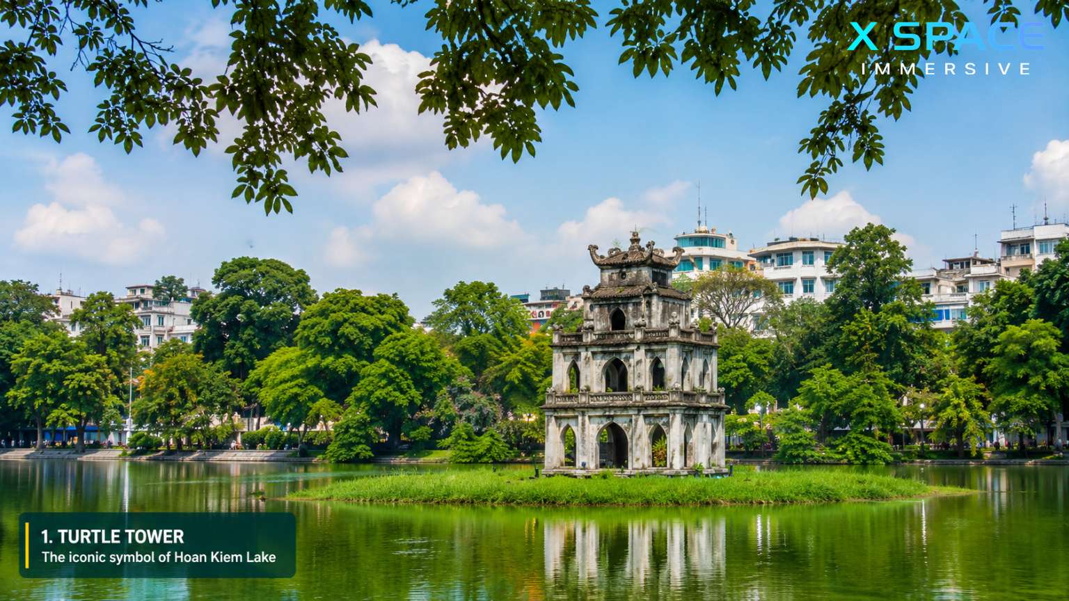 Turtle Tower standing on Hoan Kiem Lake in Hanoi, Vietnam, surrounded by lush trees and calm water