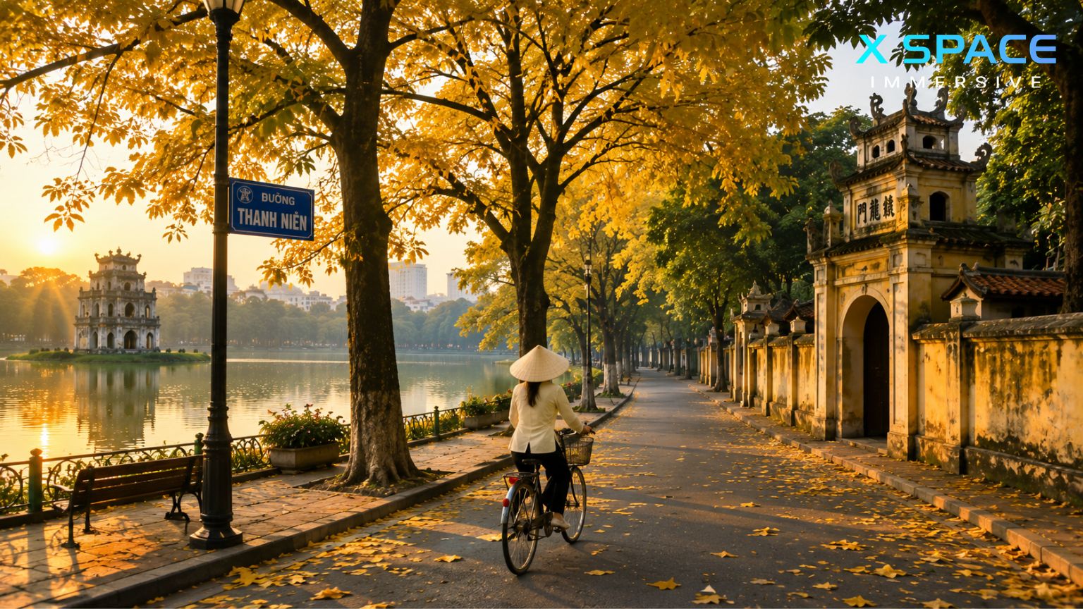 Hanoi street in autumn with golden leaves and a cyclist near the lake