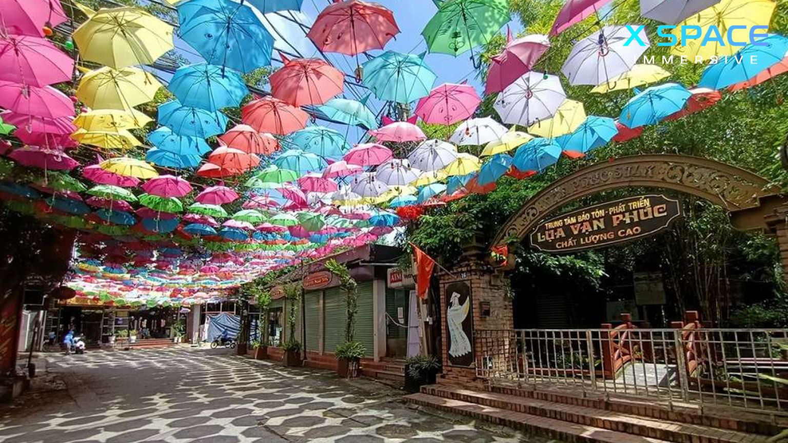 Charming street at Van Phuc Silk Village with colorful silk and lanterns